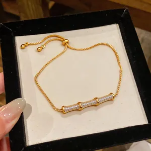 Detail of 18k gold plated bamboo link bracelet featuring sparkling cubic zirconia stones.