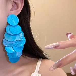 Detailed view of vibrant blue layered acrylic disc earrings with a unique marbled texture.