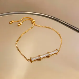 Detailed macro view of an 18k gold-plated bamboo bracelet featuring shimmering zircon accents.