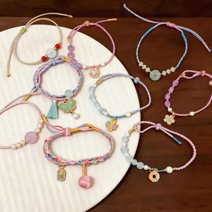 Hand-woven colorful rope bracelets with pearls and flower charms in Chinese style