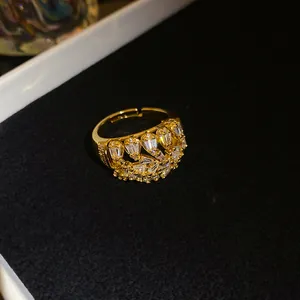 Detailed macro view of an 18k gold plated geometric hollow ring with sparkling zircons