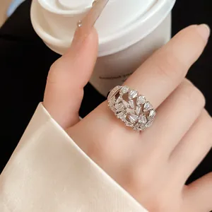 Detailed macro view of an 18k gold plated hollow open ring with sparkling geometric zircons.