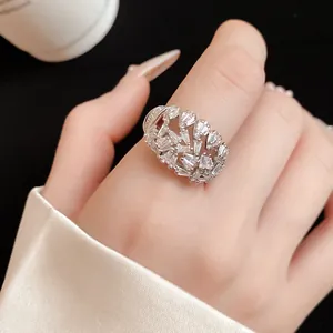 Detailed close-up of a 18k gold-plated open ring with sparkling cubic zirconia stones