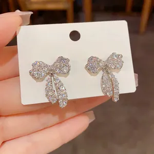 Dettaglio orecchini a lobo in argento con design a fiocco in zirconi micro-pavé brillanti
