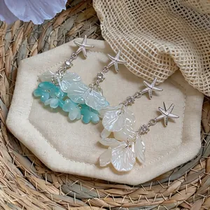 Boucles d'oreilles pompons coquillage étoile de mer et fleur style resort chic