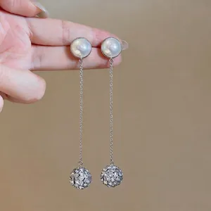 Elegant French style silver drop earrings with white pearls and sparkling rhinestone balls.