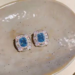 Close-up of elegant French palace style earrings featuring blue and pink rhinestones