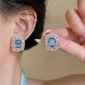 Detailed close-up of French vintage style earrings with blue and pink crystals.
