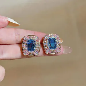 Close-up of blue and pink geometric crystal stud earrings in French vintage style