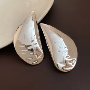 Detailed close-up view of silver water drop stud earrings with a textured surface