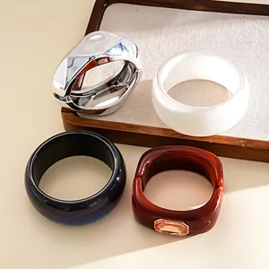 Detail view of assorted resin and metal fashion bangles featuring a rhinestone accent