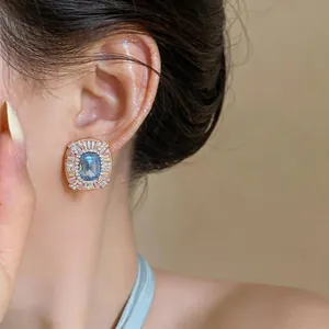 Detailed view of luxury blue and pink gemstone stud earring in French court style