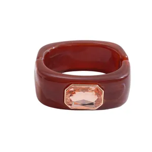 Sophisticated square amber resin bangle with a sparkling pink octagonal gemstone center