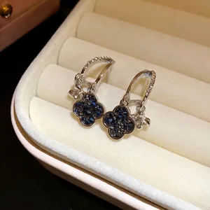 Elegant silver four-leaf clover drop earrings with blue crystal accents in gift box