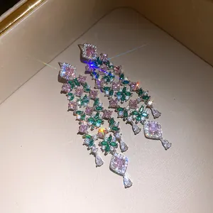 Close-up of luxury 18k gold plated pink and green zircon flower tassel earrings