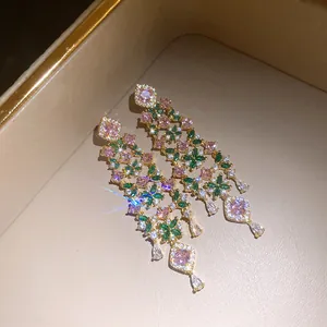 Detailed view of 18k gold plated tassel earrings with pink and green flower zircon stones