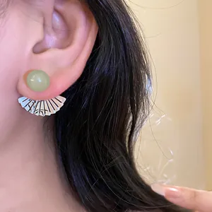 Vintage style silver needle resin stud earrings with green bead and fan pendant detail