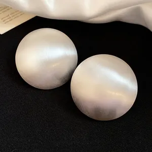 Vintage large matte silver round stud earrings featuring a minimalist metallic texture