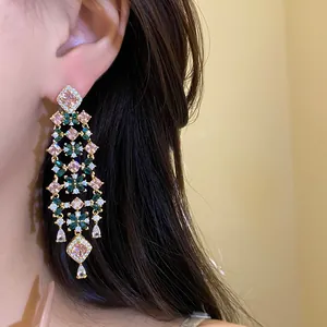 Detailed view of luxury 18k gold plated floral tassel earrings with pink and green zircon stones