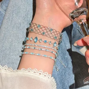 Detailed close-up showing a stack of sparkling blue crystal bracelets on a wrist
