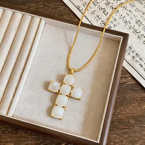 Elegant resin cross pendant necklace with golden snake chain for women jewelry.