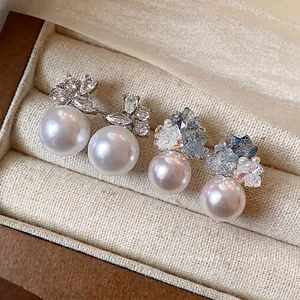 Elegant silver needle pearl stud earrings with sparkling cubic zirconia.