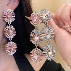 Detailed macro view showing the sparkle of vintage pink crystal three-tiered oval drop earrings.