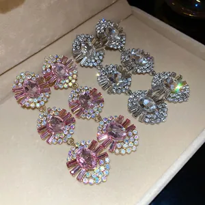 Detailed close-up of glamorous vintage oval earrings featuring sparkling pink and clear crystals
