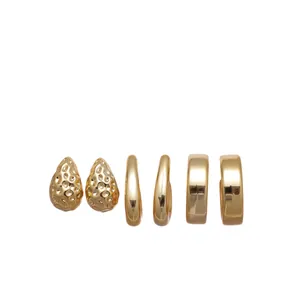 Set of six gold earrings featuring hammered teardrop and smooth C-shape designs