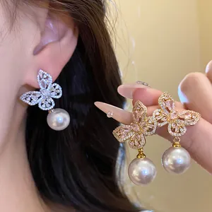 Vue détaillée des boucles d'oreilles papillon élégantes avec perles et strass scintillants