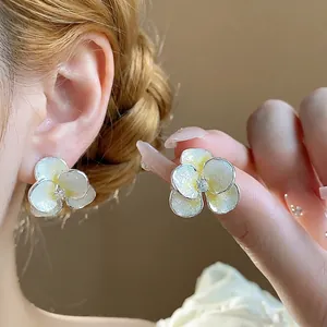 Elegant silver needle flower stud earrings with shimmering zircon and enamel detailing.