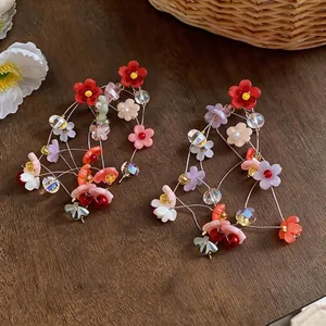 Vibrant multicolored floral resin tassel earrings with silver needles for a stylish look.