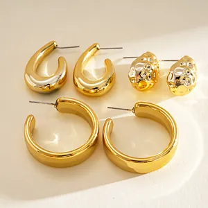 Detail view of 6-piece gold geometric earring set including C-shape and waterdrop hoops.