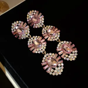 Macro detail of vintage pink crystal drop earrings encrusted with sparkling rhinestones