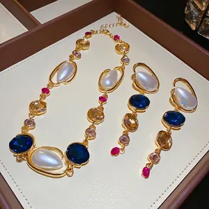 Elegant geometric pearl and rhinestone jewelry set including matching necklace and earrings.