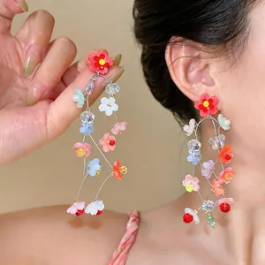 Detailed view of colorful resin flower tassel earrings with vibrant floral drops