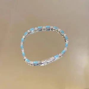 Detailed view of a light blue crystal bracelet with silver metal and sparkly stones
