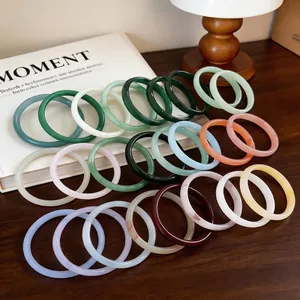 Elegant New Chinese style chalcedony bangles in various colors displayed on a desk.