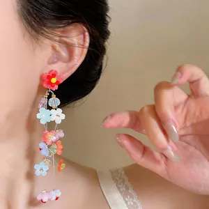 Close-up of model wearing colorful resin flower tassel earrings in dopamine style
