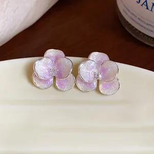 Detailed view of purple gradient flower earrings with zircon center and silver needles.