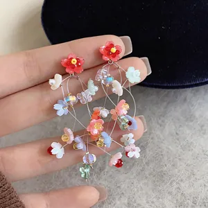 Detailed view of vibrant resin flower tassel earrings featuring delicate transparent wires