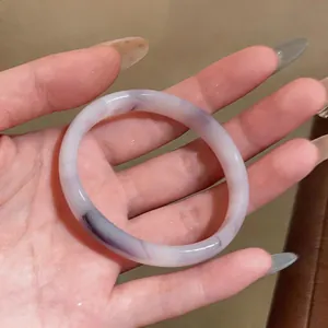 Detailed macro shot of elegant Chinese style chalcedony bangle with unique purple swirls
