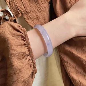Elegant lavender chalcedony bangle worn on wrist showing its smooth texture and color.