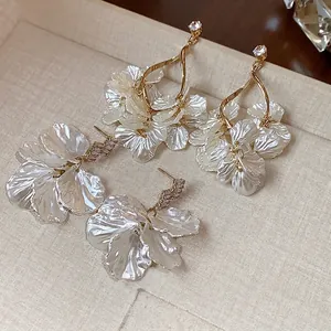 Elegant white petal shell earrings with zircon studs in a French luxury style.