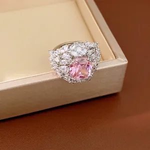 Elegant silver tone open ring featuring a large pink gemstone and clear zircon stones