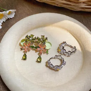 Floral zircon silver earrings with water drop pendants in elegant display