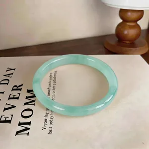 Elegant minimalist pale green chalcedony bangle bracelet with a smooth polished finish.