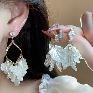 Detailed view of elegant zircon petal shell tassel earrings with golden frame accents