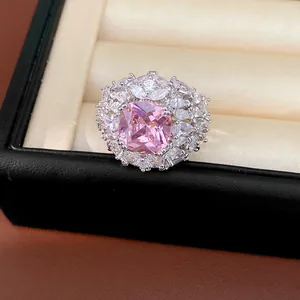 Macro detail showing the pink zircon and surrounding white stones of the royal ring