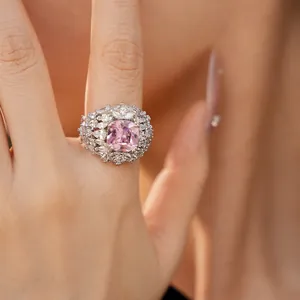 Close-up of a luxury palace style ring with a large pink gemstone and cubic zirconia.